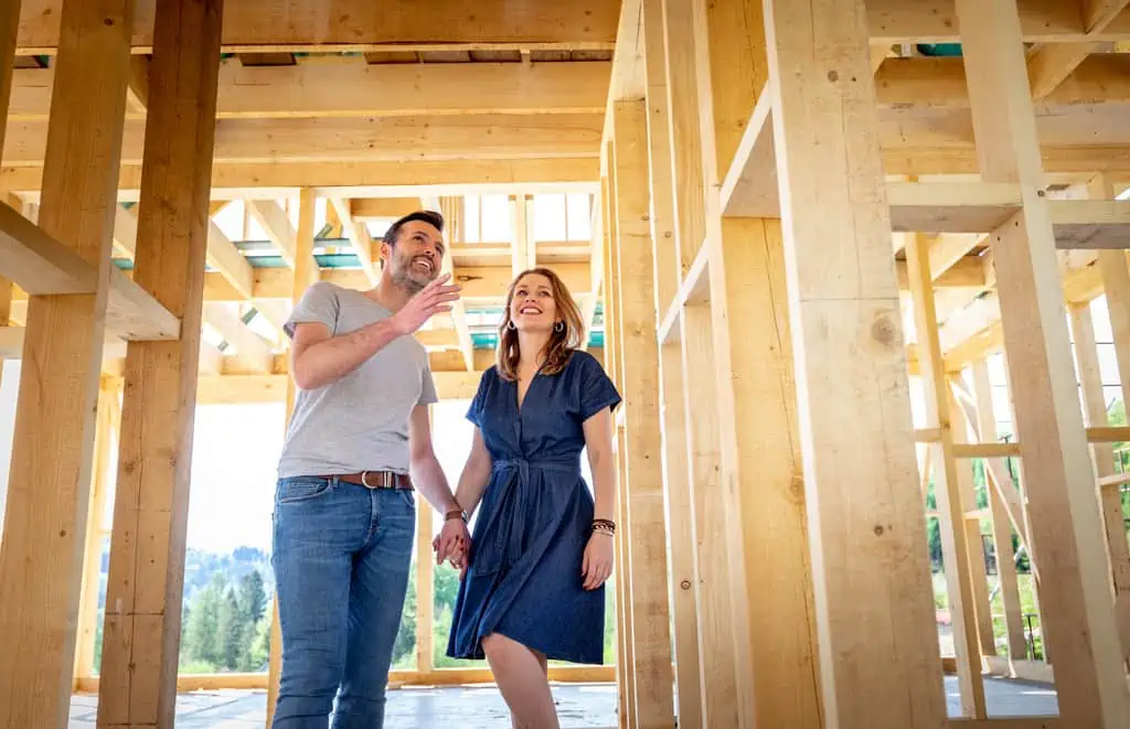 couple checking out a home being built using a home construction loan